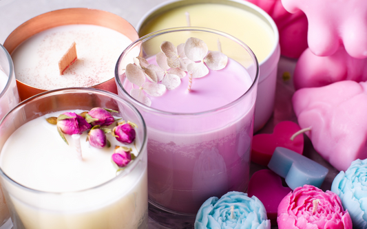 Bougies parfumées artisanales en verre avec fleurs séchées et couleurs pastel, ambiance romantique et décoration intérieure douce et élégante.