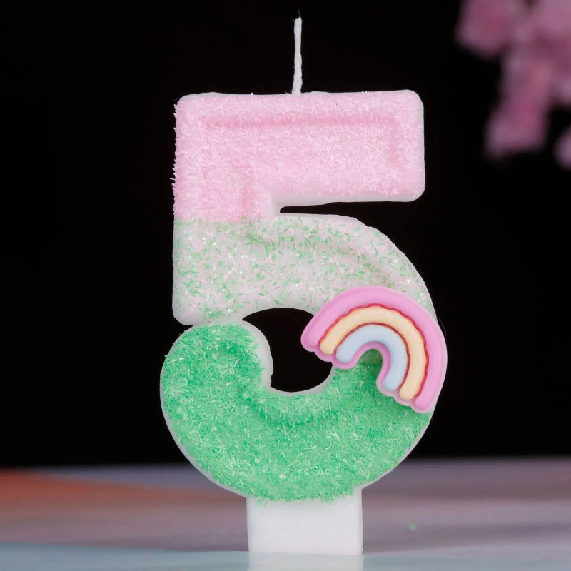 Bougie Anniversaire Arc en Ciel Enchanté, de couleur rose et vert, le chiffre de la bougie est le 5 et sur un fond noir.