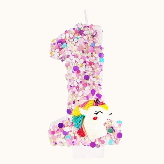 Bougie Anniversaire Licorne Explosion de Paillettes, le chiffre représenté est le 1, de couleur rose et sur fond beige clair.