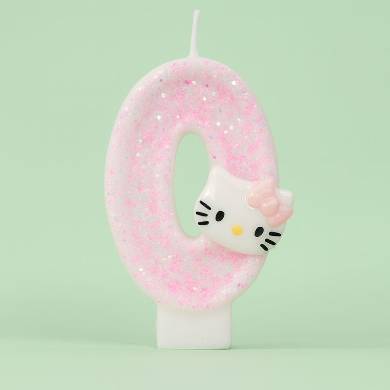 Bougie Anniversaire So Cute, de couleur rose à paillette, le chiffre est le 0 et sur fond vert clair.