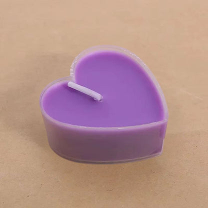 Bougie Décorative Chauffe Plat Cœur Lot 9 pièces, de couleur violette et sur fond beige foncé.