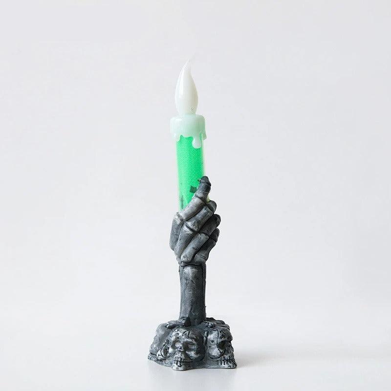 Bougie Halloween Lumière Hantée, de couleur verte et noire, sur fond gris clair.