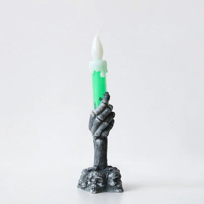 Bougie Halloween Lumière Hantée, de couleur verte et noire, sur fond gris clair.