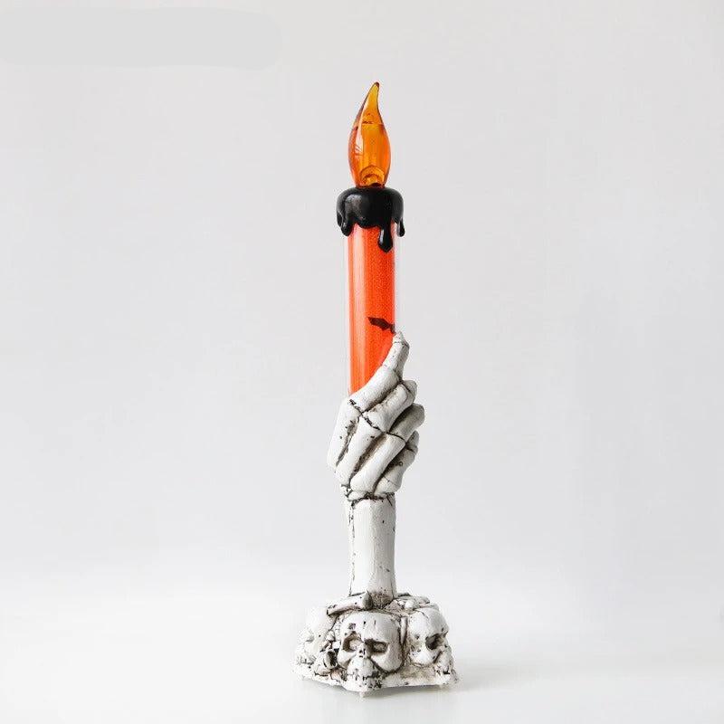 Bougie Halloween Lumière Hantée, de couleur blanche et orange, sur fond gris clair.