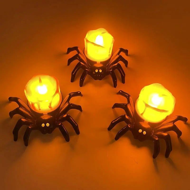Bougie Halloween Terreur Lumineuse, les bougies en forme d'araignée sont allumées et sur un fond orange.