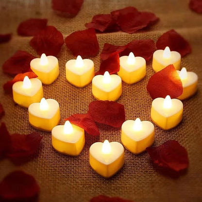 Bougie LED Chauffe Plat Cœur disposé en forme de cœur, allumée et dans une ambiance romantique. La lumière est doré.