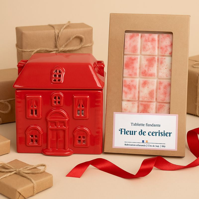 Brule Parfum Chalet Enchanté, présenté avec une tablette de fondant parfumé à côté ainsi que des cadeaux. Ambiance festive.