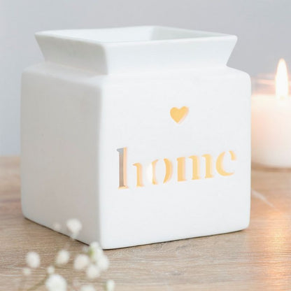 Brule Parfum Home Minimaliste, de couleur blanc ajouré « home » illuminé par une bougie, lumière chaleureuse et style épuré pour fondants parfumés.