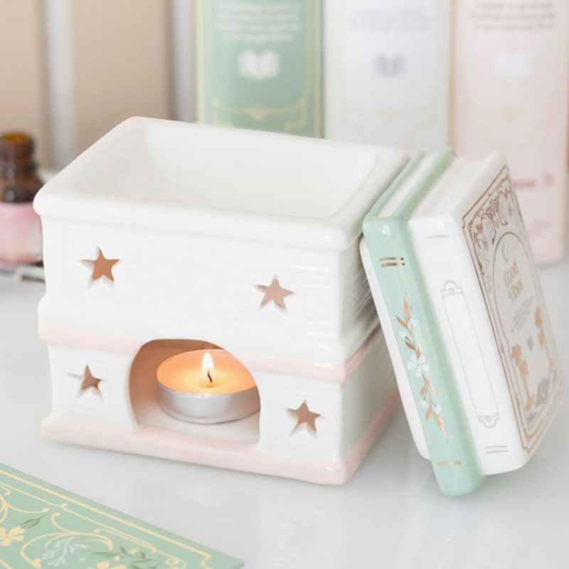Brule Parfum Livre des Merveilles ouvert avec couvercle amovible, diffuseur en céramique pour fondants parfumés, décoration romantique.