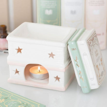 Brule Parfum Livre des Merveilles ouvert avec couvercle amovible, diffuseur en céramique pour fondants parfumés, décoration romantique.