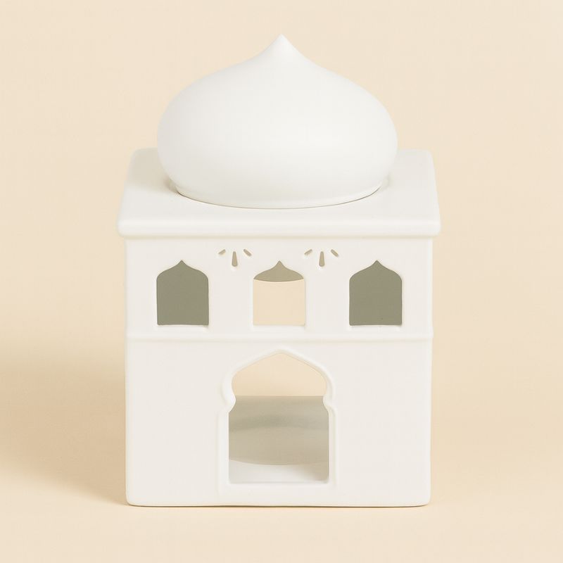 Brule Parfum Lueur d’Orient, e couleur blanche en forme de palais oriental et sur fond beige clair.