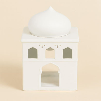 Brule Parfum Lueur d’Orient, e couleur blanche en forme de palais oriental et sur fond beige clair.