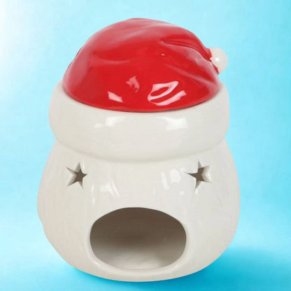 Brule Parfum Pére Noël Magique en céramique, vue arrière avec étoiles ajourées. Fond bleu.