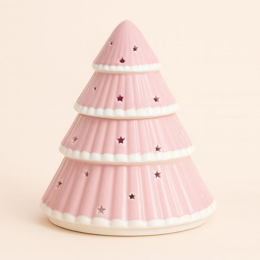 Brule Parfum Sapin Rose Féérique, de couleur rose et en forme de sapin avec des petites étoiles et sur fond beige clair.