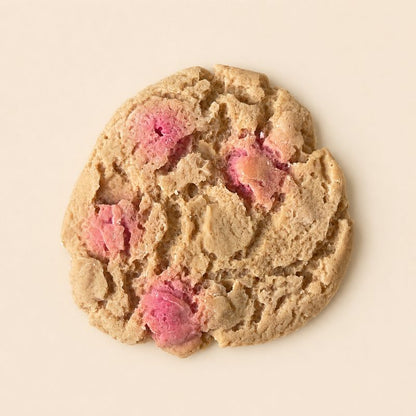 Fondant Parfumé Cookie Saveur Clafoutis en forme de cookie aux éclats roses sur fond beige clair.