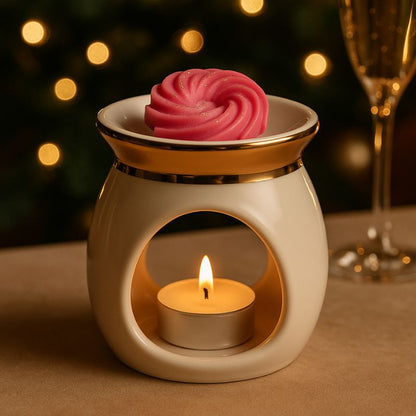 Fondant Parfumé Spirale Fruits Rouges, disposé dans un brûleur doré et allumé dans une ambiance festive.