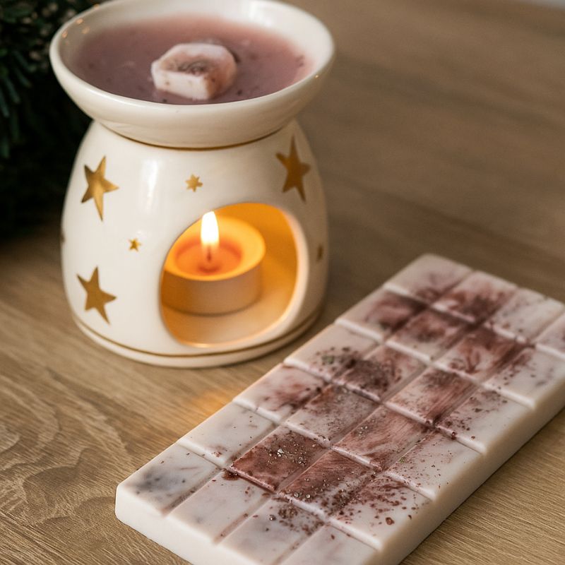 Fondant Parfumé Tablette Marron Glacé, la tablette est posée sur une table et il y a un brûleur qui est allumé à côté. Ambiance scandinave.