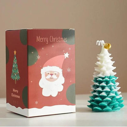 Bougie Noël Magique et Sapin Senteur d’Hiver, de couleur blanche et verte, avec sa boite de protection.